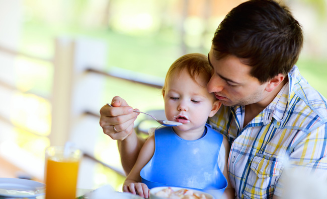 Young father and his daughter having breakfast