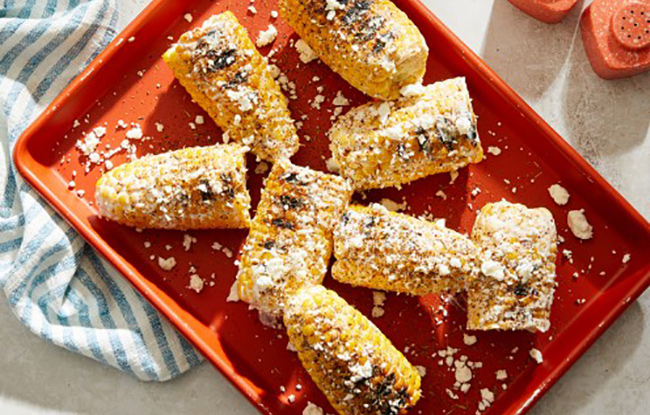 Corn on the Cob with Tzatziki on red plate